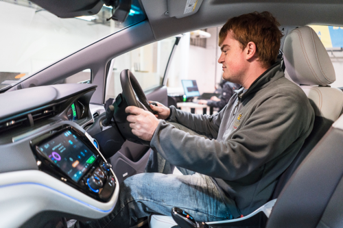 Student behind the wheel of self-driving car.