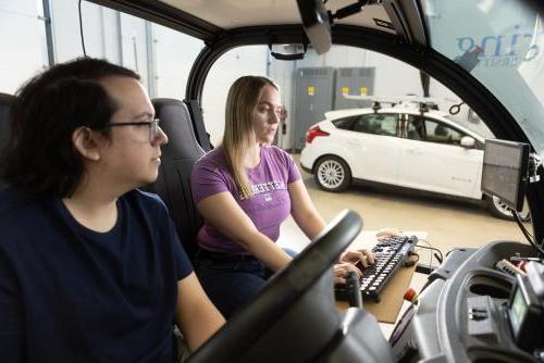 Undergraduate students work on a self-driving vehicle in Kettering University's Mobility Research Center.